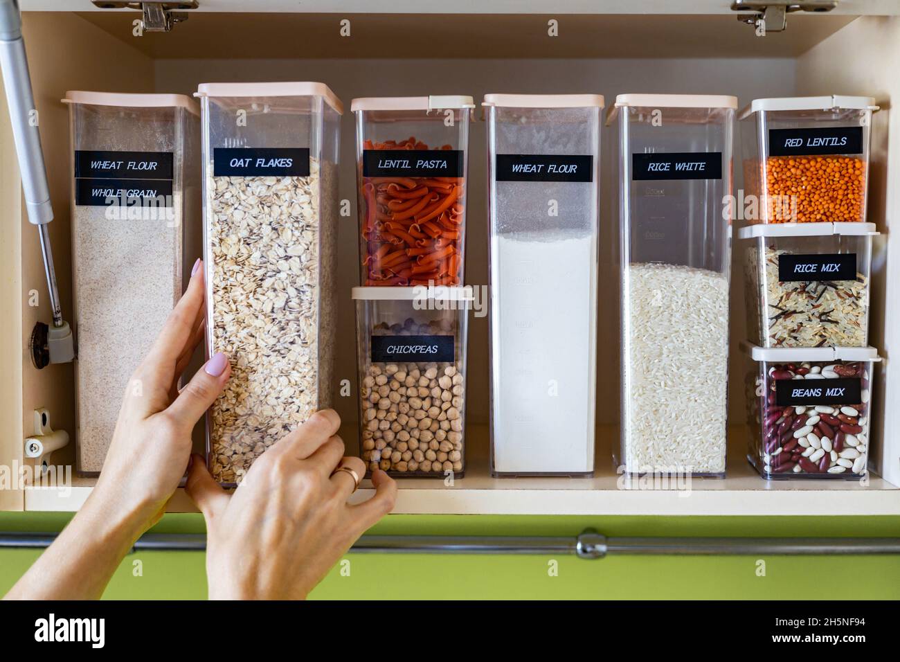 Storage pasta in boxes use Konmari method at wooden cupboard in kitchen