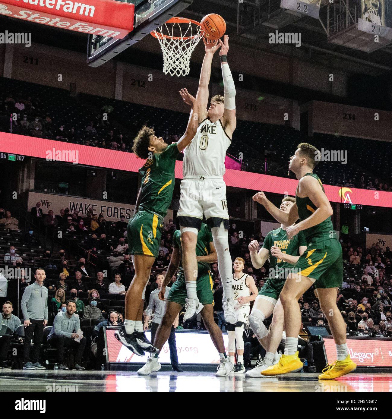Winston-Salem, NC, USA. 10th Nov, 2021. William & Mary Tribe guard Julian  Lewis (2) comes up short as he drfends the shot from Wake Forest Demon  Deacons forward Jake LaRavia (0) during