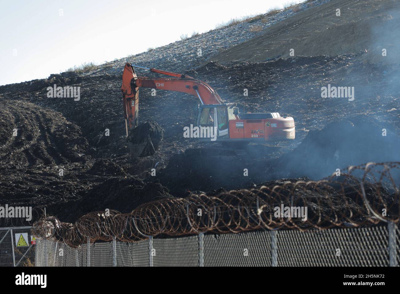 An excavator seen at the Hrybovytchi landfill which is under reclamation (artificial restoration of soil fertility and vegetation after man-made disturbance of nature). The only legal place for garbage collection from Lviv and surrounding villages. It has been operating since 1958 close to the village of Velyki Hrybovychi. The landfill area is over 38 hectares. On May 28, 2016, a large fire broke out on the territory of the Hrybovytsia landfill causing a collapse of solid waste where three rescuers died under the rubble. (Photo by Mykola Tys/SOPA Images/Sipa USA) Stock Photo