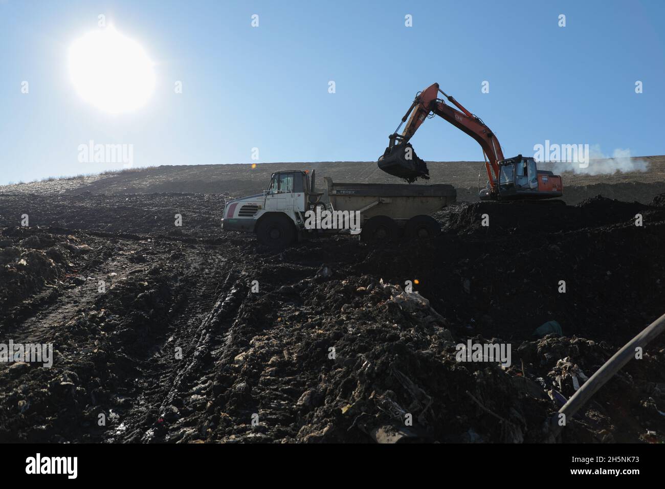 An excavator seen at the Hrybovytchi landfill which is under reclamation (artificial restoration of soil fertility and vegetation after man-made disturbance of nature). The only legal place for garbage collection from Lviv and surrounding villages. It has been operating since 1958 close to the village of Velyki Hrybovychi. The landfill area is over 38 hectares. On May 28, 2016, a large fire broke out on the territory of the Hrybovytsia landfill causing a collapse of solid waste where three rescuers died under the rubble. (Photo by Mykola Tys/SOPA Images/Sipa USA) Stock Photo