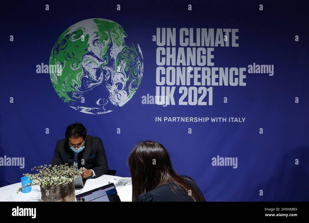 Glasgow, UK. 9th Nov, 2021. People work at the ongoing 26th session of the Conference of the Parties (COP26) to the United Nations Framework Convention on Climate Change in Glasgow, Scotland, the United Kingdom, Nov. 9, 2021. Credit: Han Yan/Xinhua/Alamy Live News Stock Photo