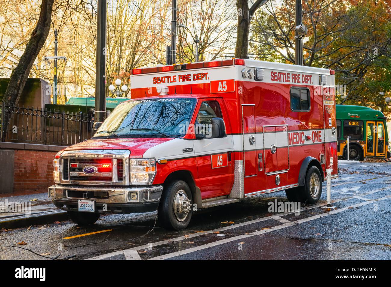 Seattle - November 09, 2021; Seattle Fire Department Medic One ambulance in the downtown area of Seattle on a wet fall day with lights flashing Stock Photo