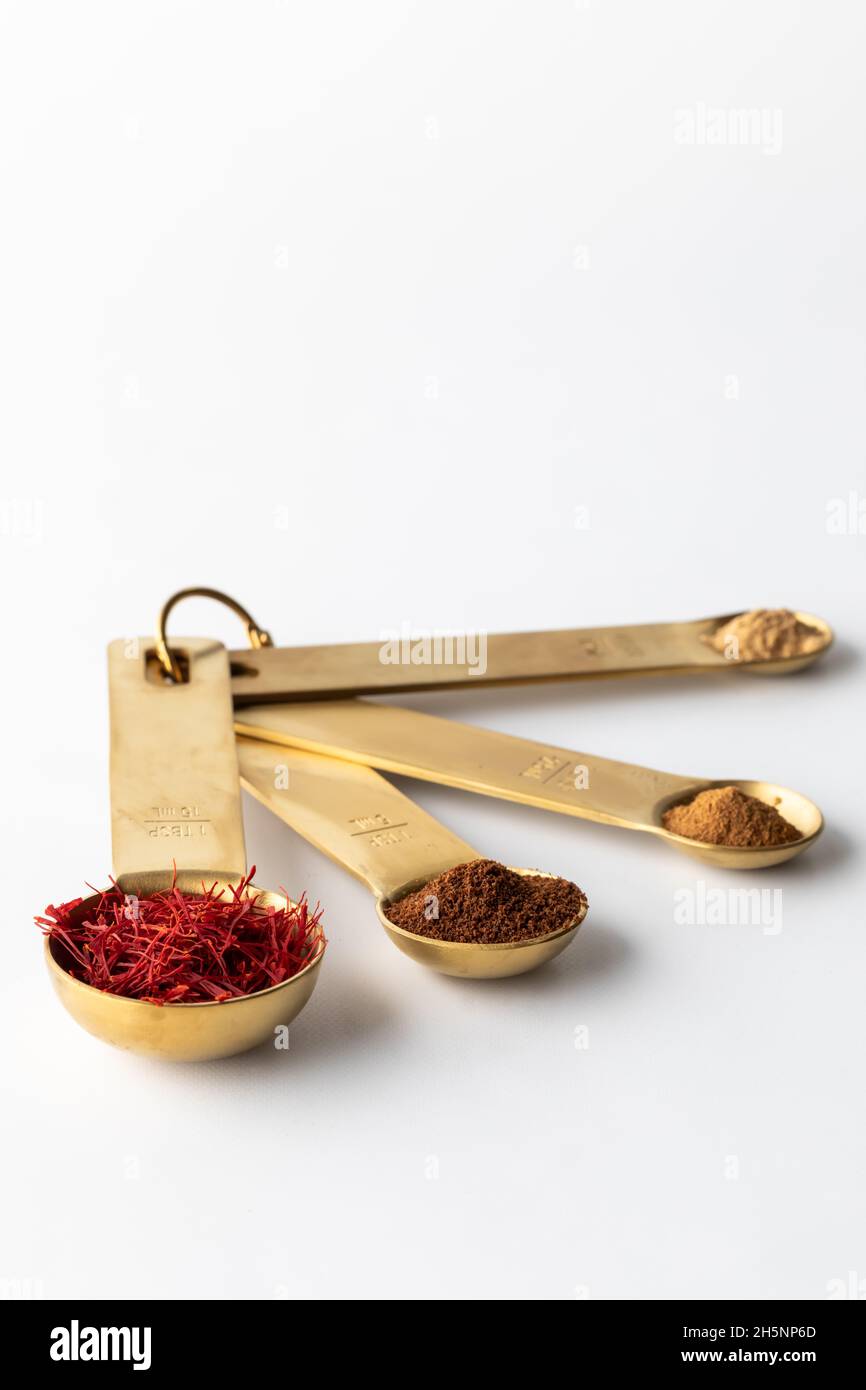 Measuring spoons filled with spices used in Spanish cooking Stock Photo