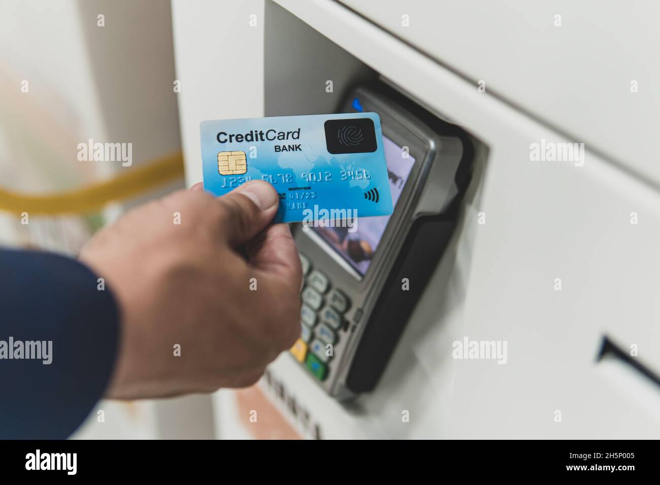Man paying with NFC technology on credit card, restaurant, shop. Contactless ticket payment. Stock Photo