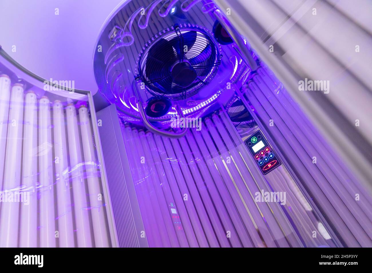 Close up of vertical solarium for tanning skin in spa salon, ultraviolet rays color Stock Photo