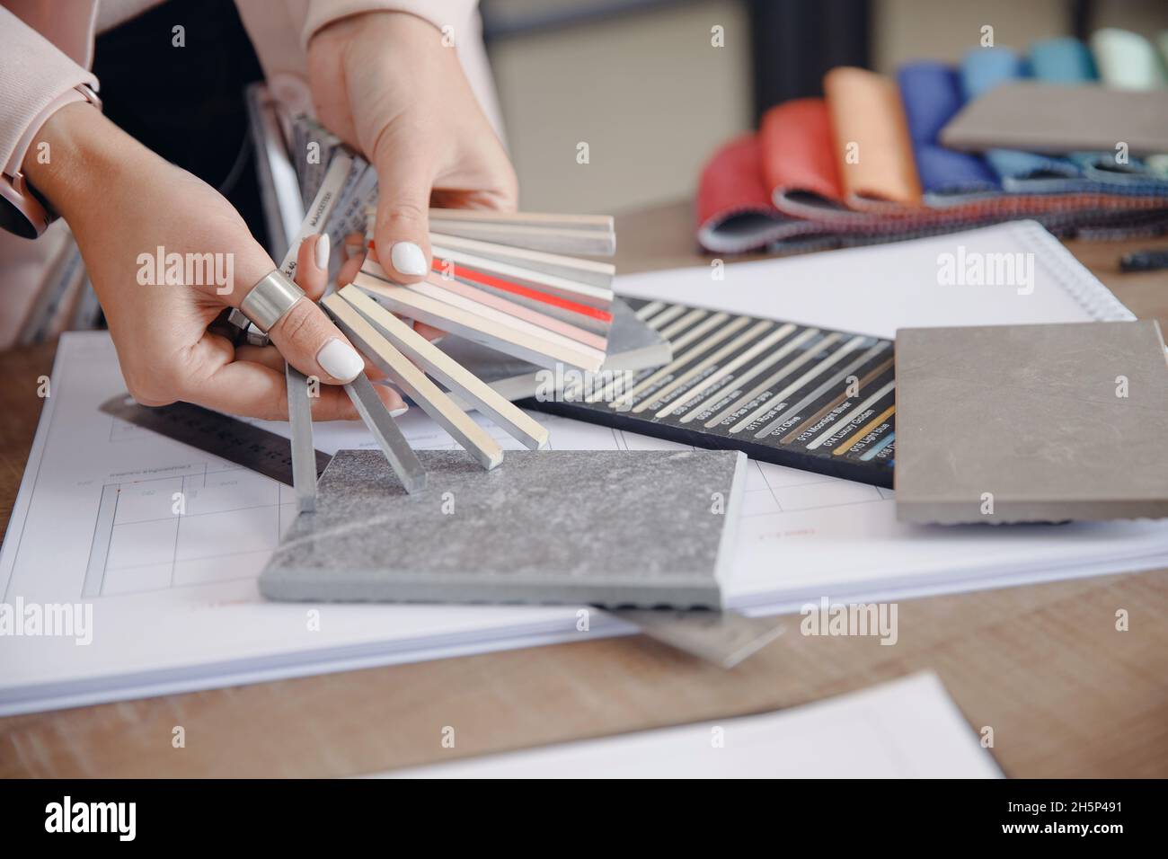 Closeup hand of Woman interior designer chooses grout color for ceramic tiles. Stock Photo
