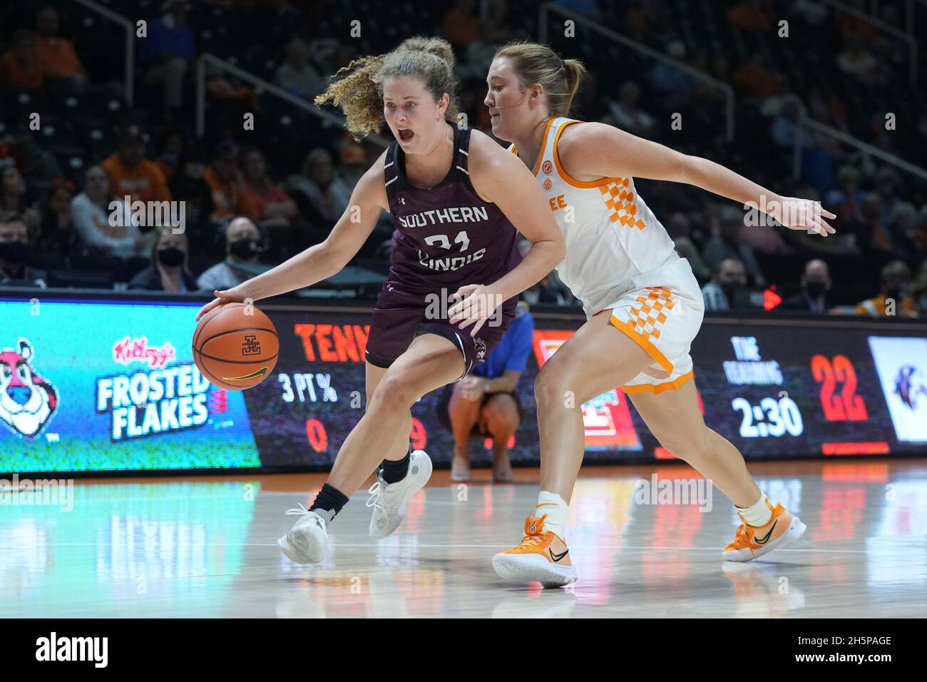 November 10, 2021: Payton McCallister #21 of the Southern Illinois Salukis  drives to the basket against Tess Darby #21 of the Tennessee Lady Vols  during the NCAA basketball game between the University