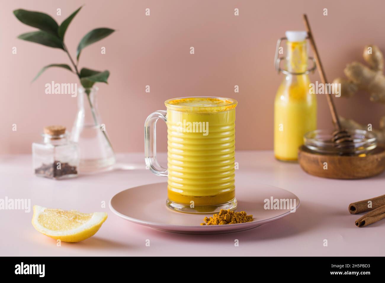 Latte turmeric on a pink background. Moon milk for better sleep. Copy