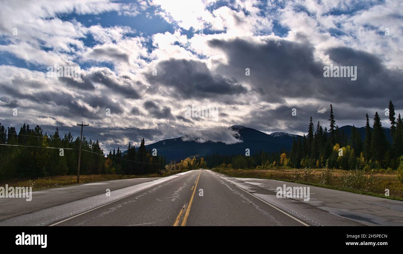 Beautiful landscape with diminishing perspective of Yellowhead Highway (16) north of McBride in Robson Valley, British Columbia, Canada in autumn. Stock Photo