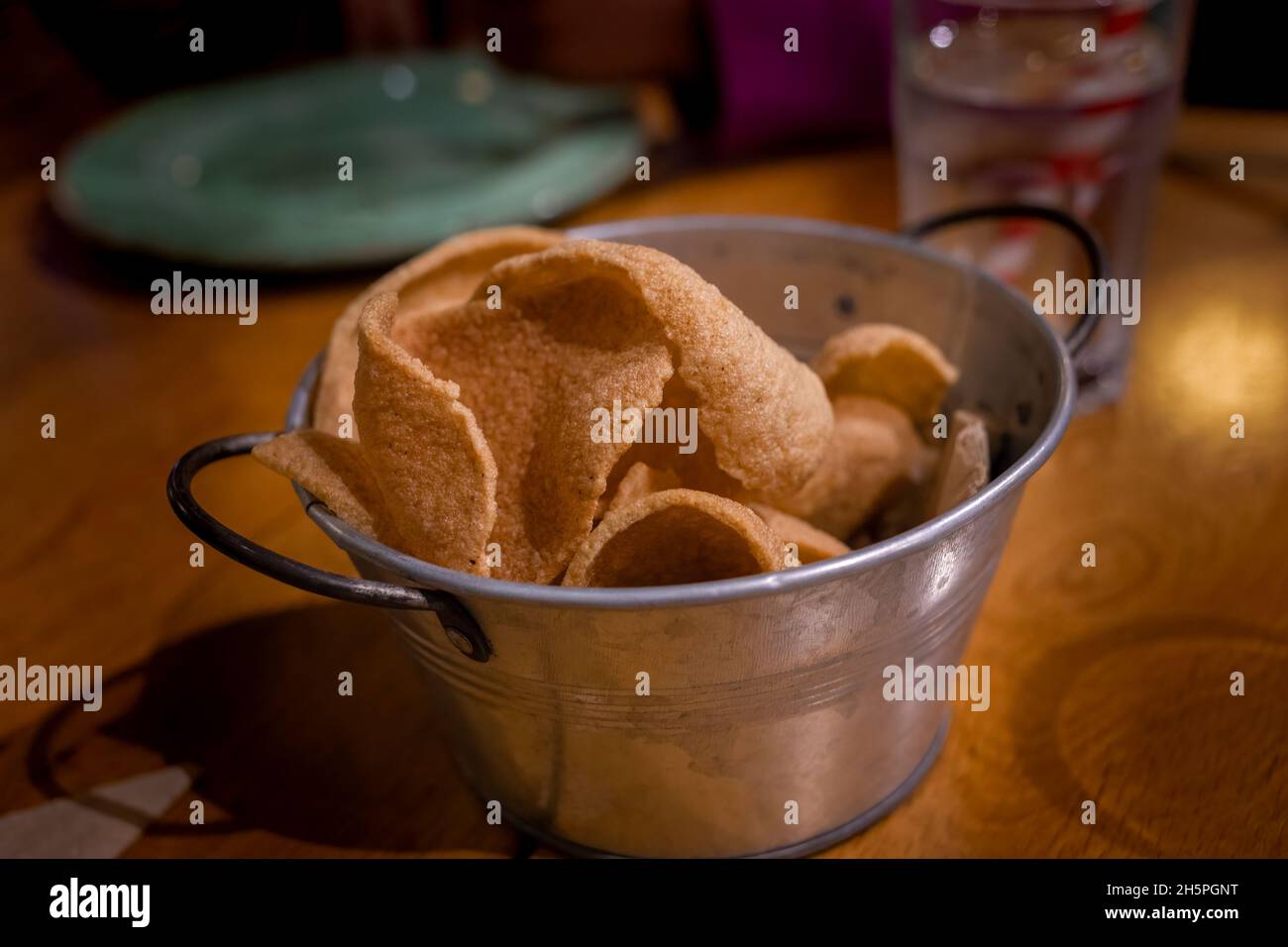 Bowl of spicy thai prawn crackers in a restaurant setting Stock Photo