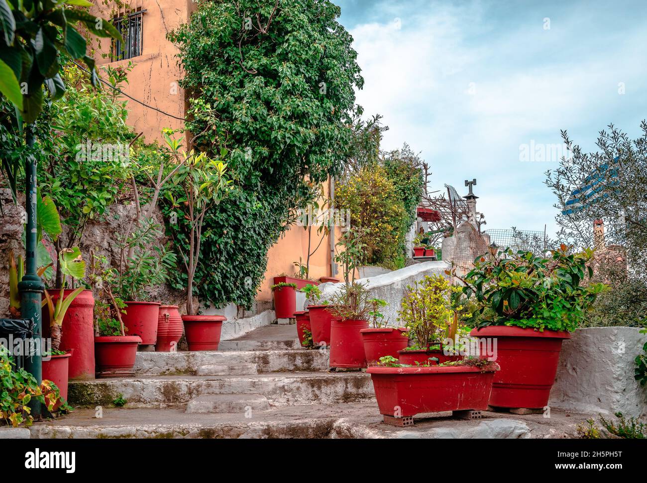 Stone steps, narrow alley in Anafiotika, a scenic tiny neighborhood of Athens, Greece. Anafiotika is part of the old historical neighborhood of Plaka, Stock Photo