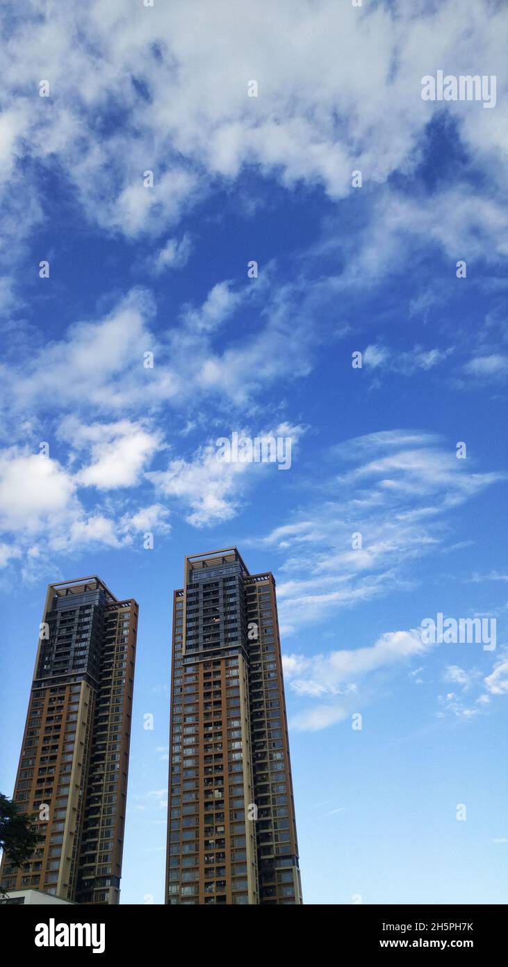 Residential buildings under blue sky and white clouds Stock Photo - Alamy