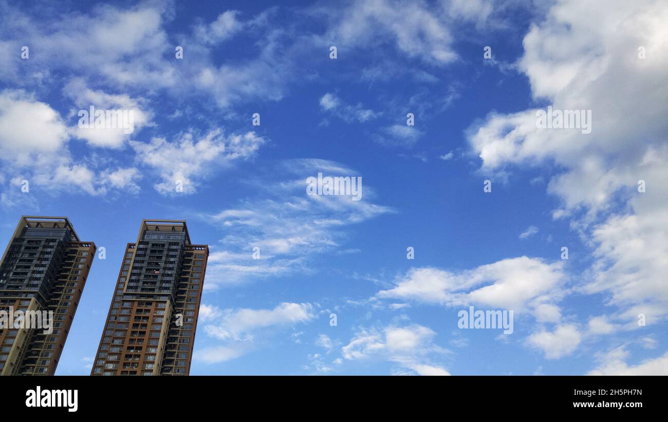 Residential buildings under blue sky and white clouds Stock Photo - Alamy