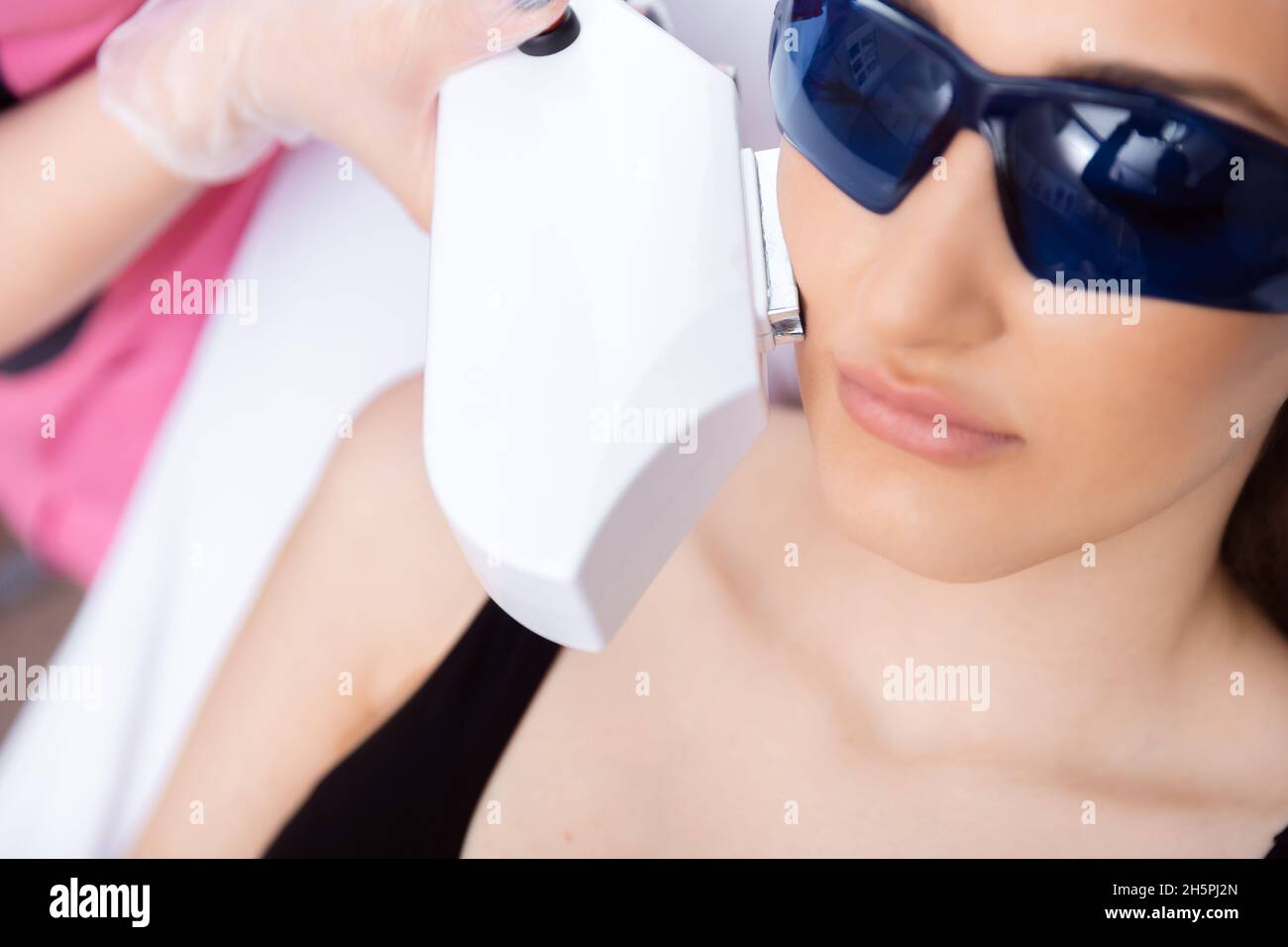 Master carries out removal moustache of unwanted hair laser on face