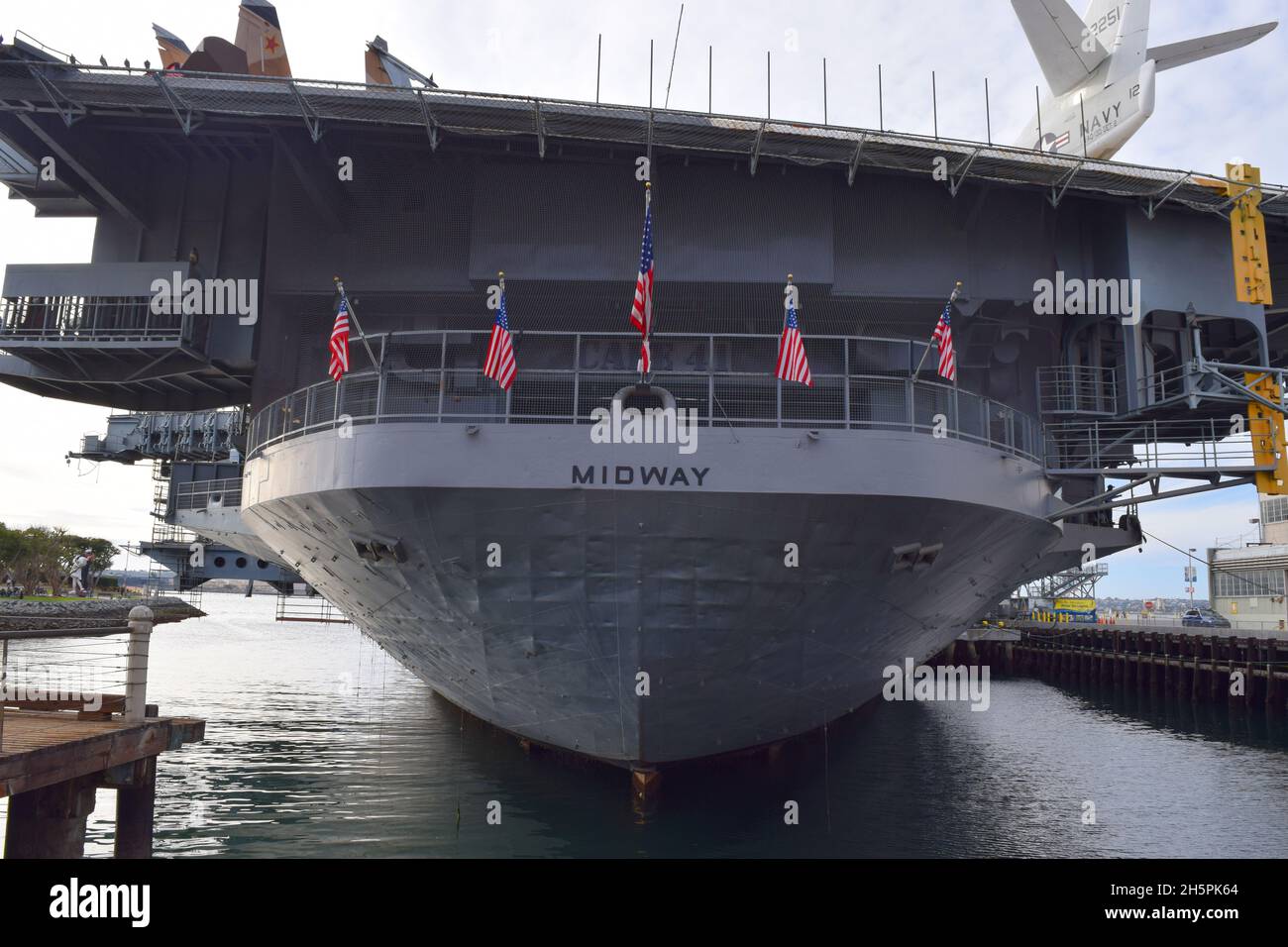 View of the stern of USS Midway, now a museum ship moored in San Diego, California.  Its name 'Midway' is stamped on the center section. Stock Photo