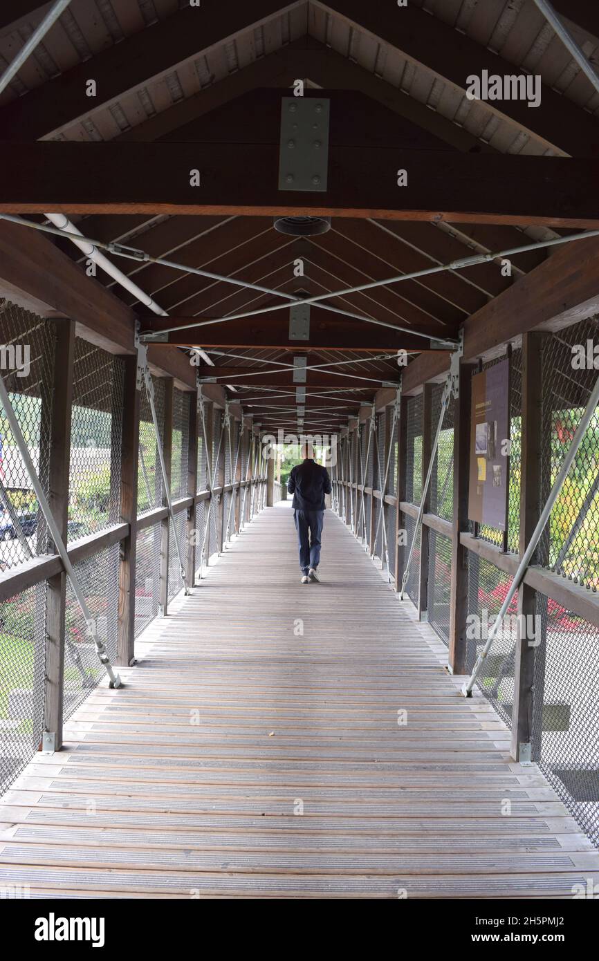 Man walking through a covered bridge near Snoqualmie Falls, Washington Stock Photo