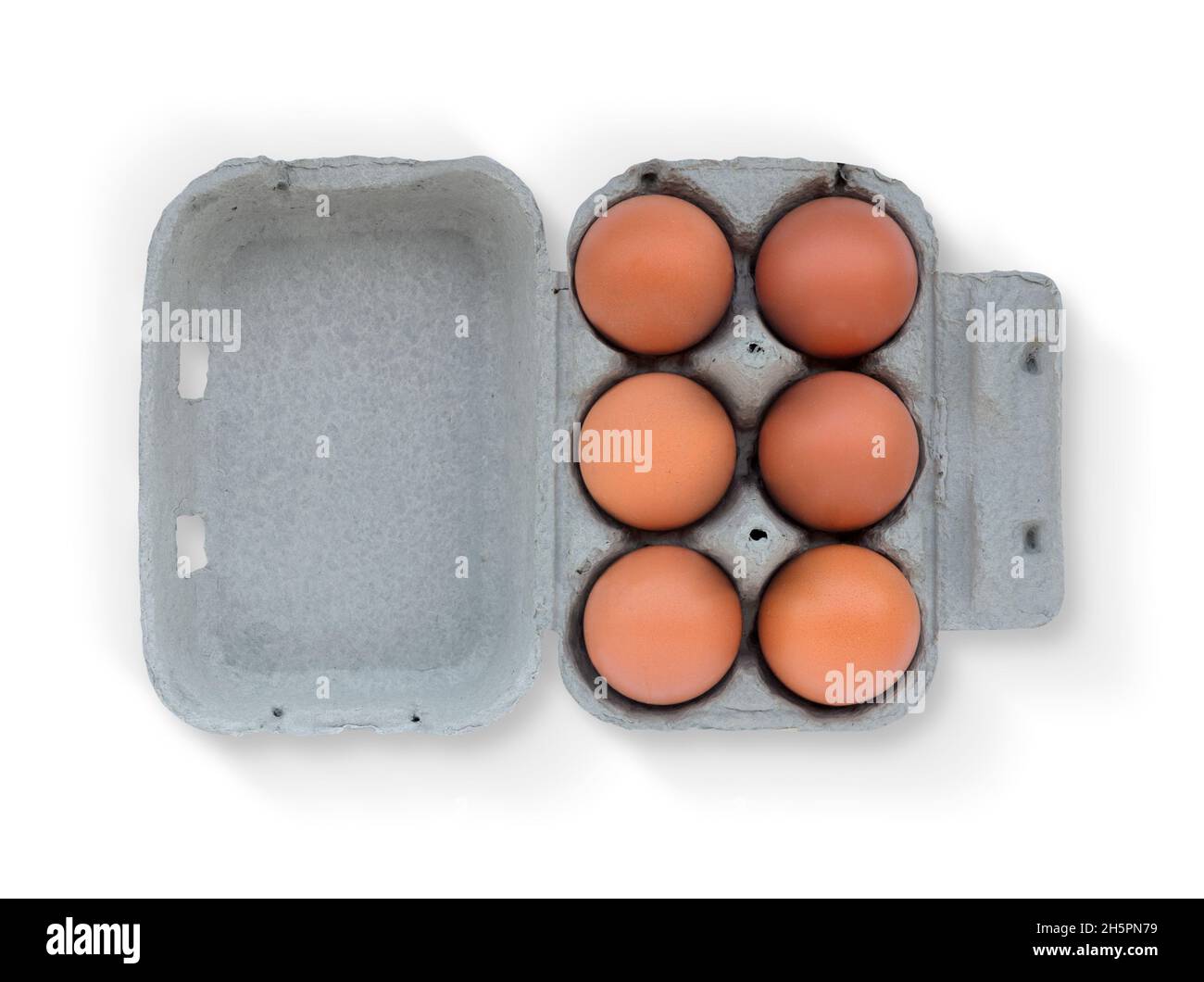 Six Brown eggs on cardboard box isolated on white background Stock Photo
