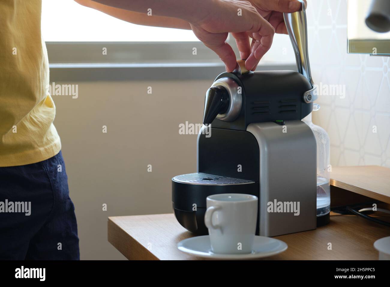 Unrecognizable man preparing coffee in a coffee machine with capsules Stock  Photo - Alamy