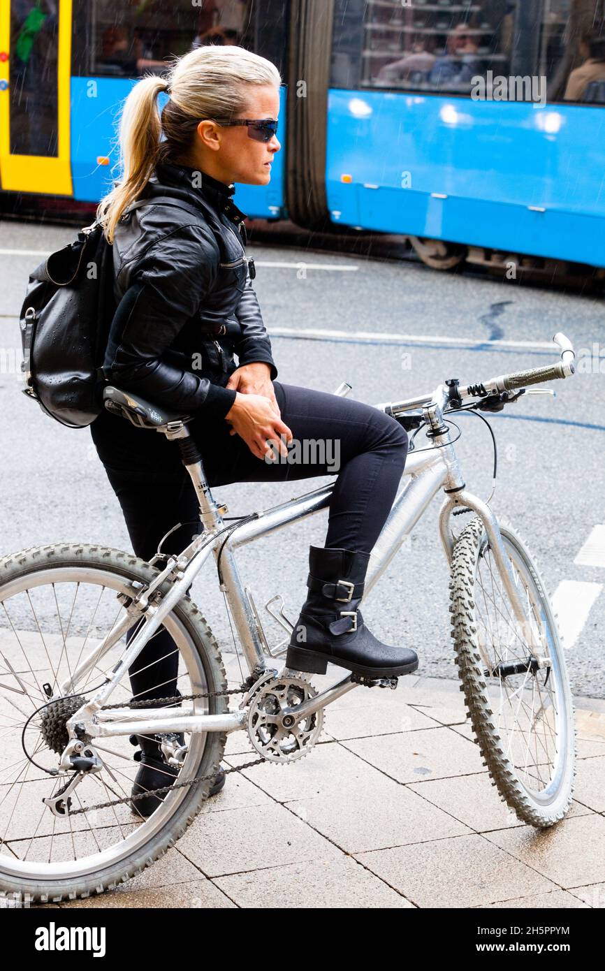 Germany woman bike city on street Stock Photo