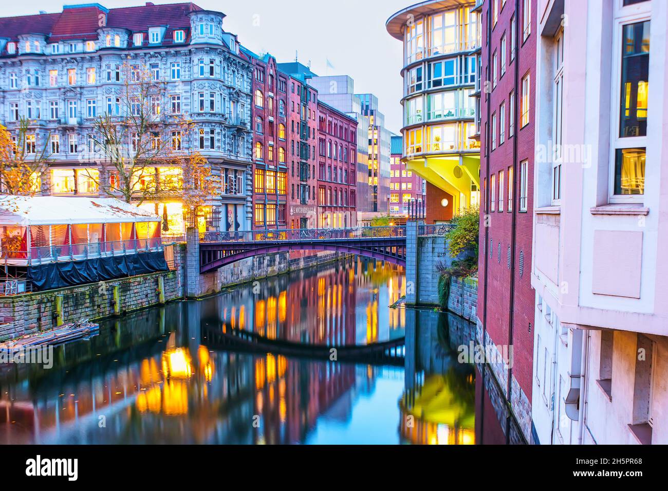 The scenic neighborhood in Altstadt with Herrengrabenfleet canal with beautiful high buildings and bridges, Hamburg, Germany Stock Photo