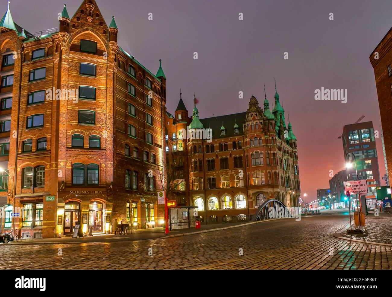 HAMBURG, GERMANY - NOVEMBER 20, 2019: The night scene in Speicherstadt district among scenic restored historical warehouses, on Nov 20 in Hamburg Stock Photo