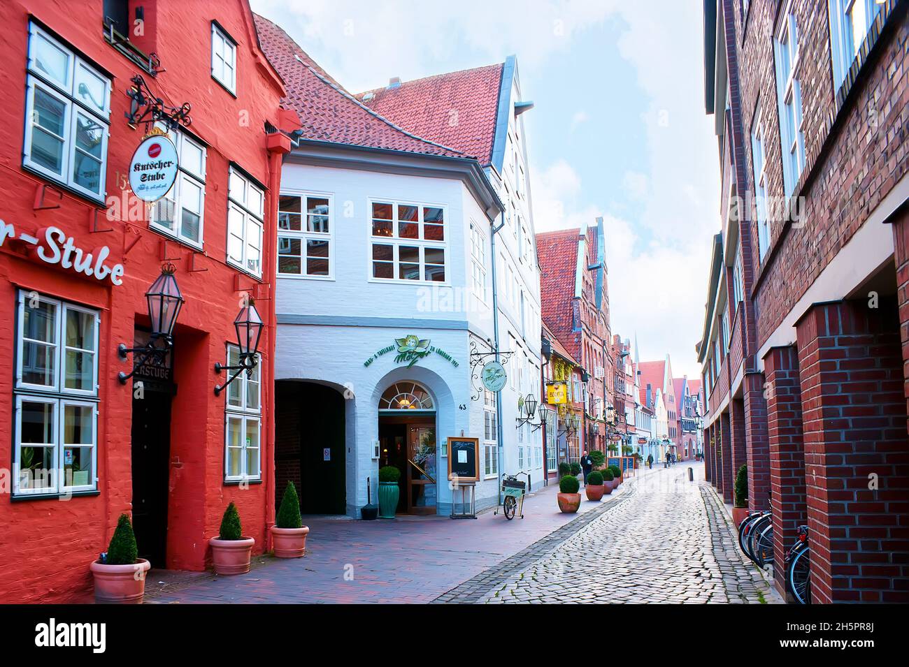 LUNEBURG, GERMANY - NOVEMBER 20, 2019: Medieval narrow street in Altstadt with cafes and restaurnats, on November 20 in Luneburg, Germany Stock Photo