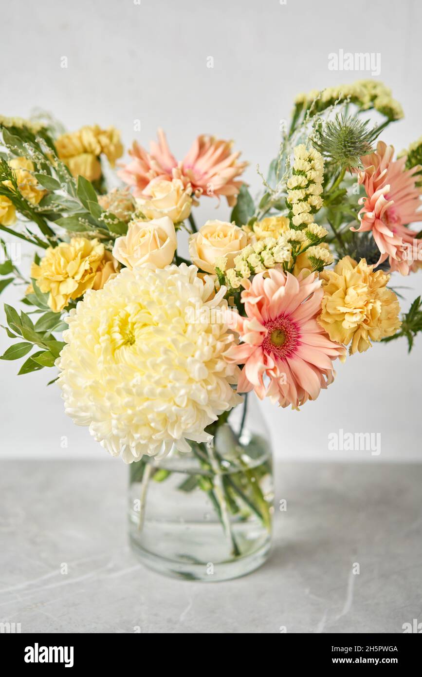 Finished flower arrangement in a vase for home. Flowers bunch, set for interior. Fresh cut flowers for decoration home. European floral shop. Delivery Stock Photo