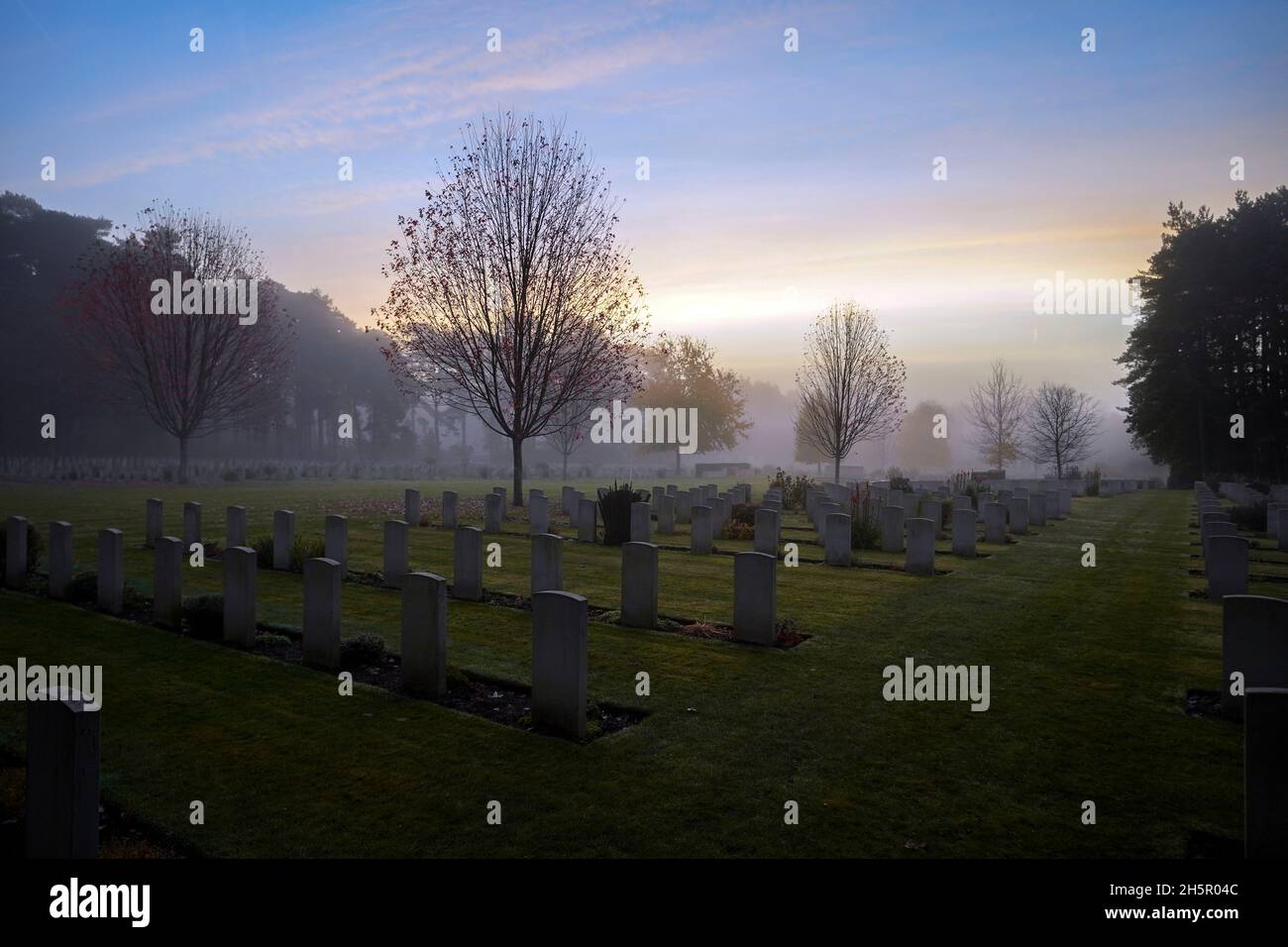 Sunrise on Armistice Day over First and Second World War graves at the Commonwealth War Graves Commission's Brookwood Military Cemetery in Woking Surrey. People across the UK will observe a two minute silence at 11 o'clock to remember the war dead. Picture date: Thursday November 11, 2021. Stock Photo