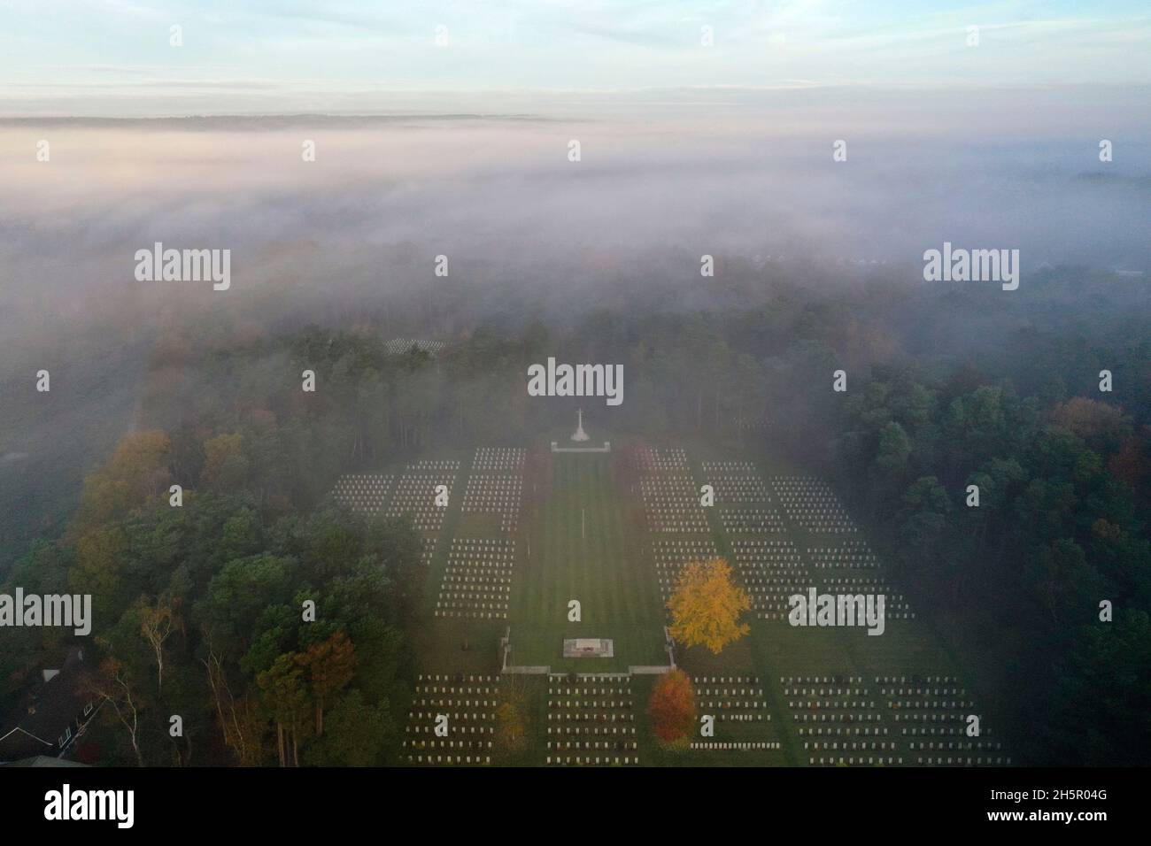The early morning mist on Armistice Day over First and Second World War graves at the Commonwealth War Graves Commission's Brookwood Military Cemetery in Woking Surrey. People across the UK will observe a two minute silence at 11 o'clock to remember the war dead. Picture date: Thursday November 11, 2021. Stock Photo