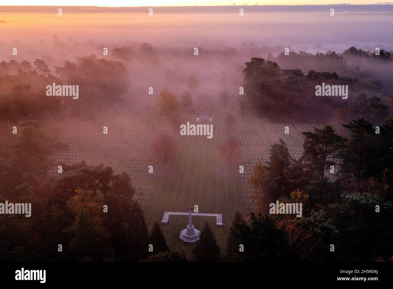 Sunrise on Armistice Day over First and Second World War graves at the Commonwealth War Graves Commission's Brookwood Military Cemetery in Woking Surrey. People across the UK will observe a two minute silence at 11 o'clock to remember the war dead. Picture date: Thursday November 11, 2021. Stock Photo