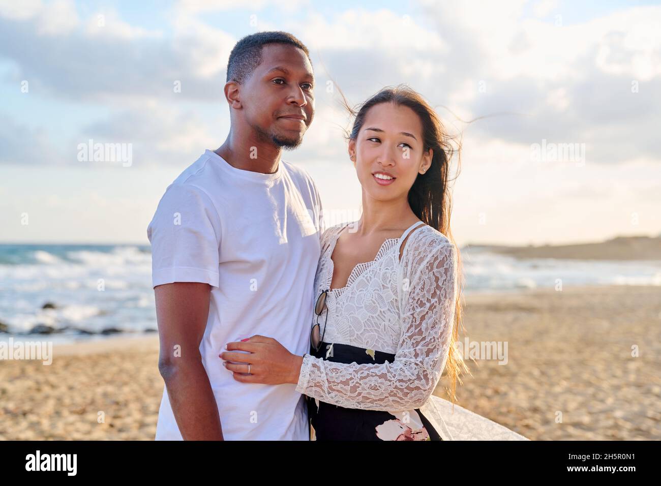 Portrait of a happy young beautiful couple on the beach Stock Photo