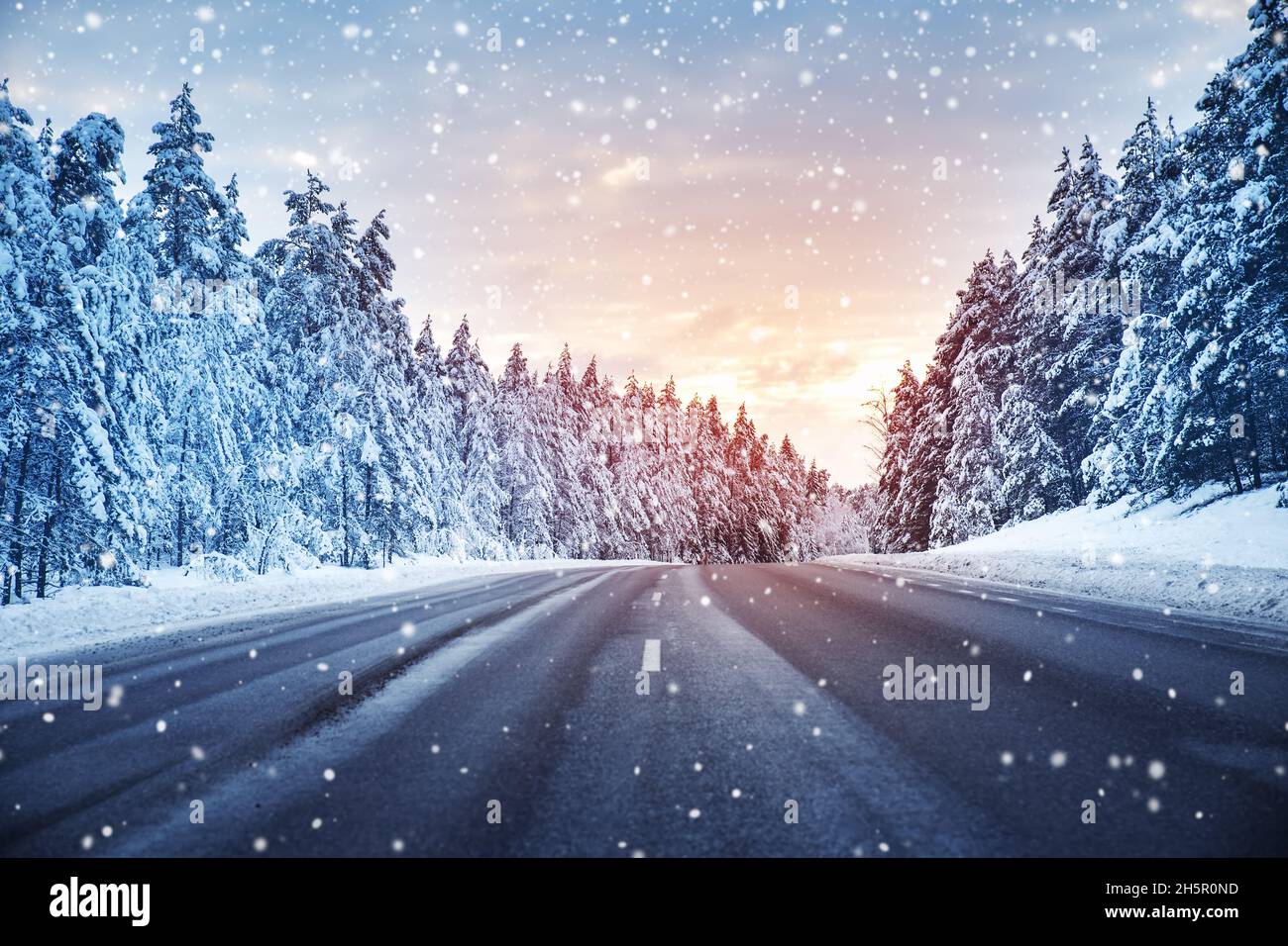 Beautiful view of the snowy curve country road in snowfall Stock Photo ...