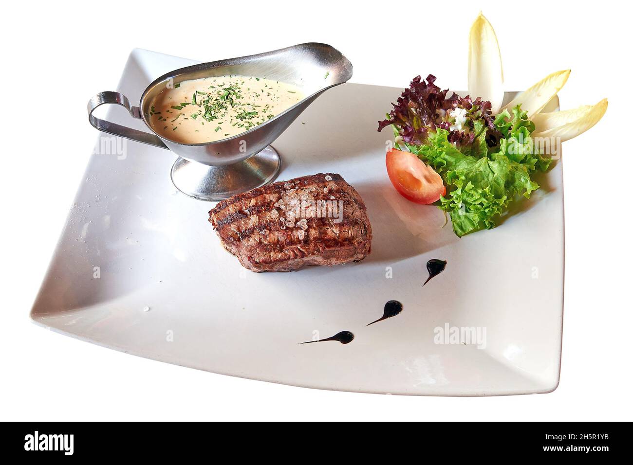 Well done Beef steack with sauce and lettuce isolated on white with clipping path Stock Photo