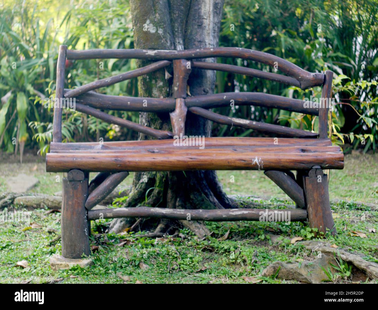 a chair made of wood in a garden Stock Photo