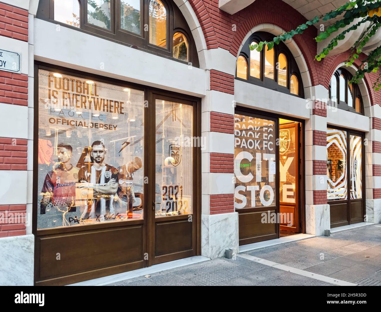 Thessaloniki, Greece PAOK FC official store facade with double eagle club logo. Day view exterior of boutique shop selling merchandise of football sports team, at the city center. Stock Photo