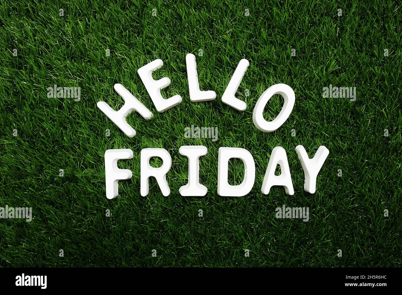 Hello Friday alphabet letter on green grass background Stock Photo