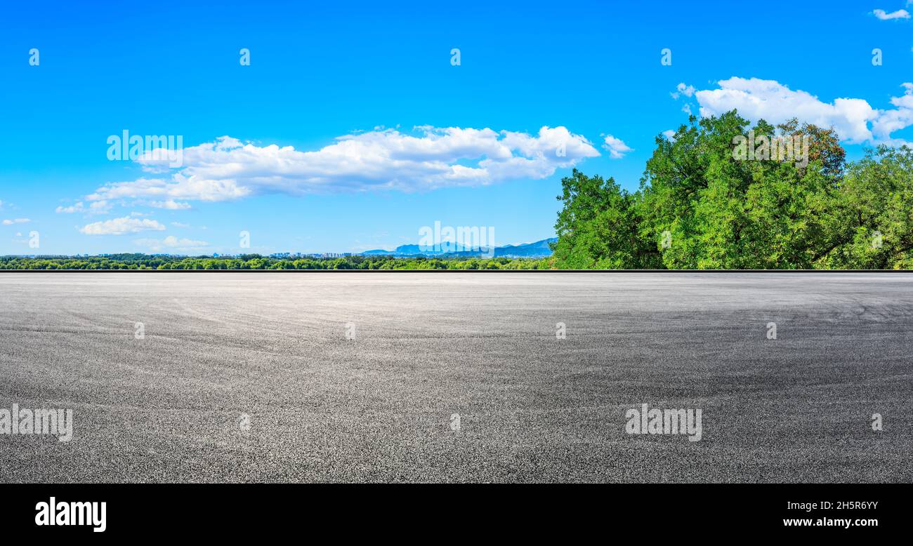 Empty racing track road and green forest with mountain landscape in the ...