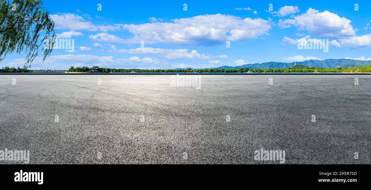 Empty racing track road and green forest with mountain landscape in ...