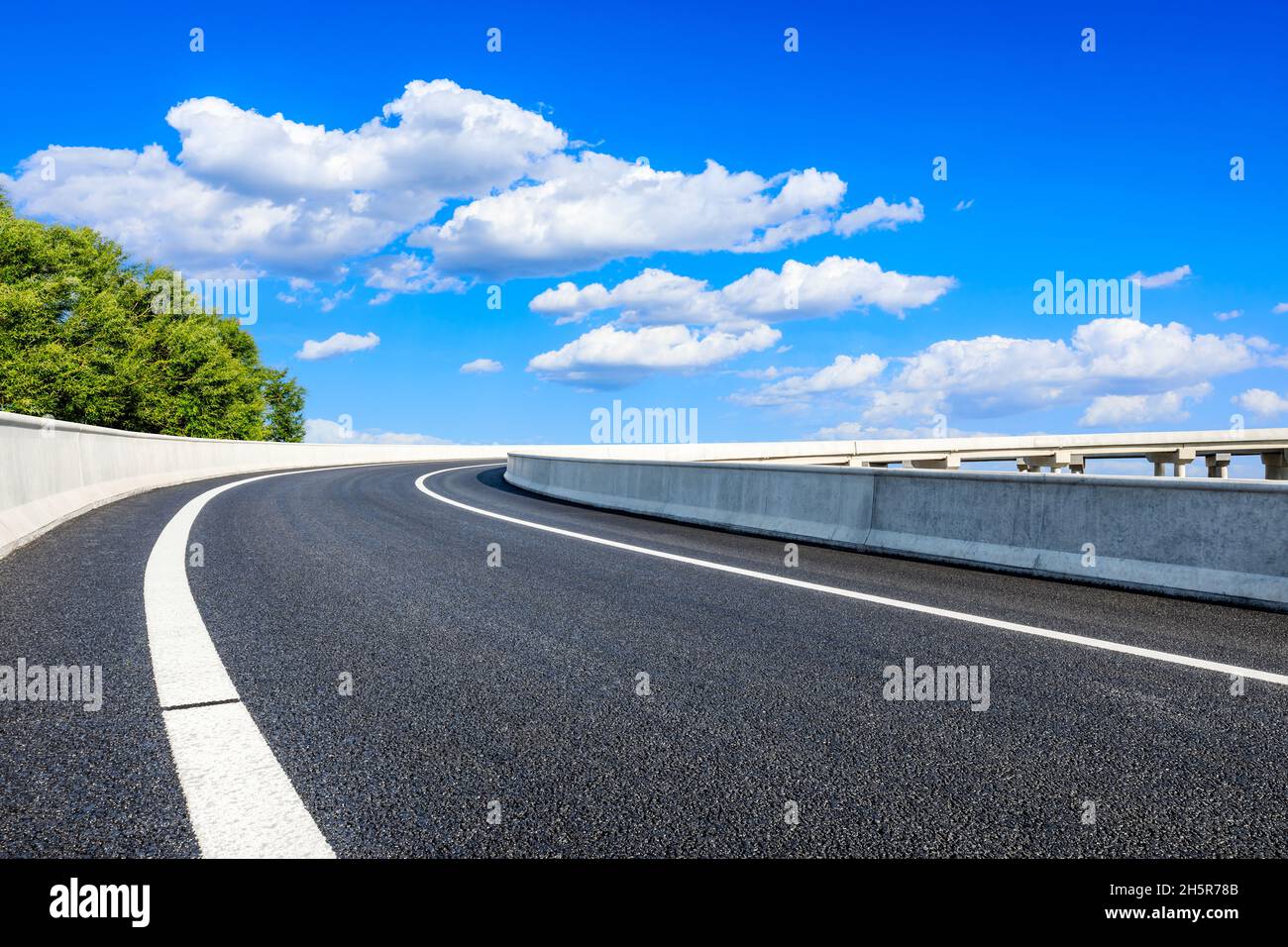 New asphalt road and blue sky with white clouds Stock Photo - Alamy