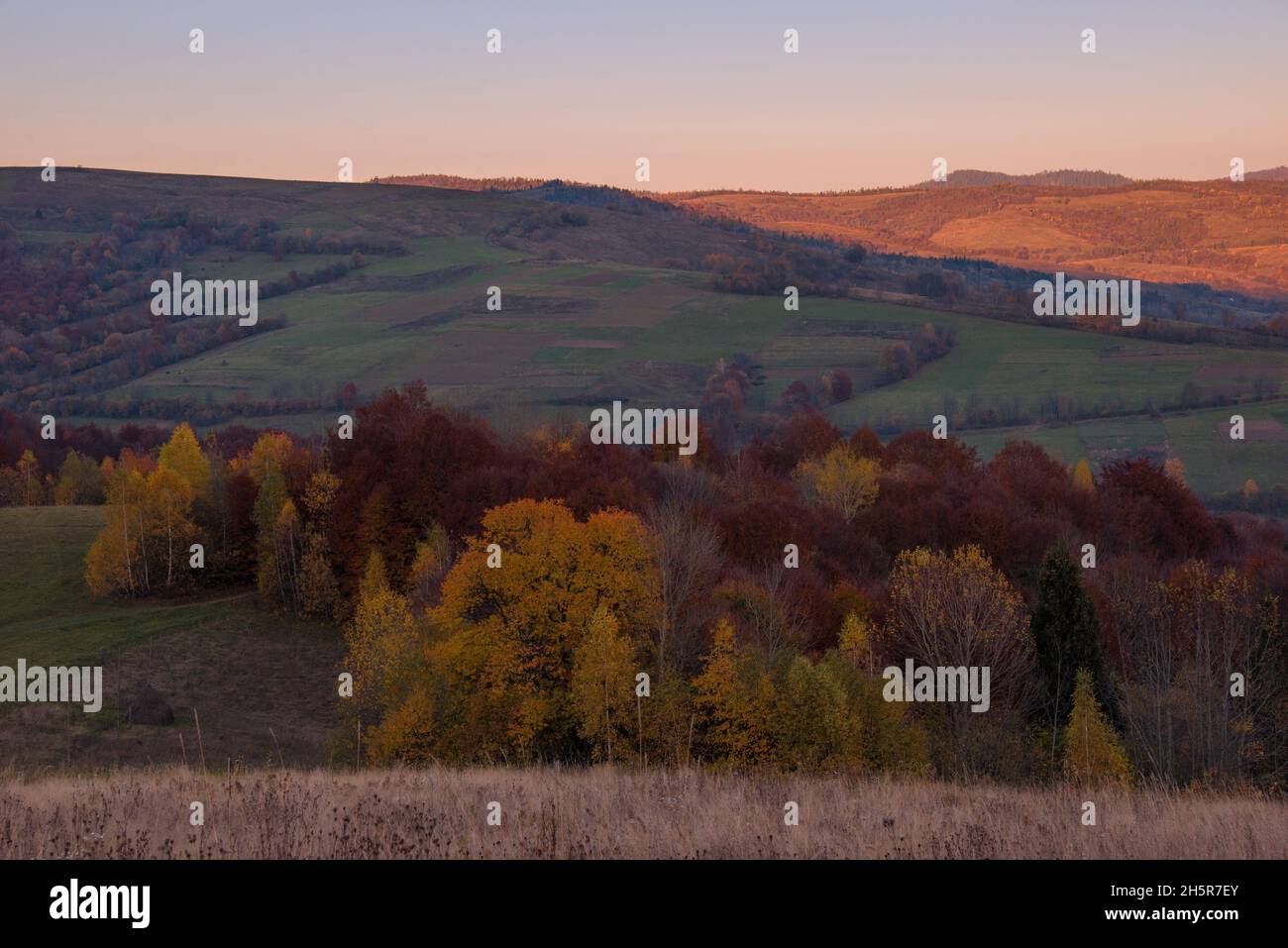 View of hills of Water Dividing ridge covered in red, orange and yellow ...