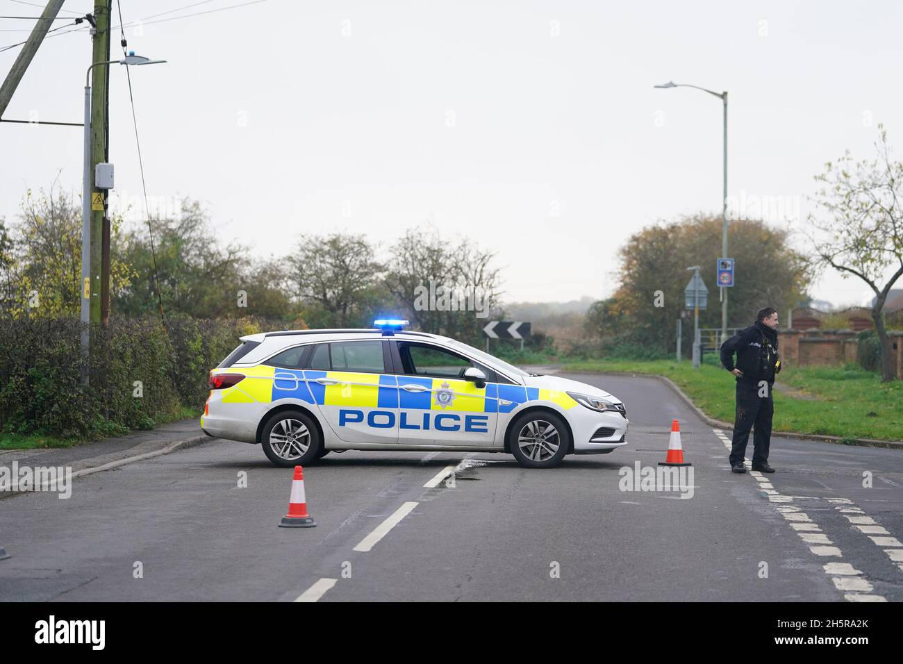 A police car blocks access to the scene in Meadow Lane, North Hykeham, near Lincoln, where a school bus has overturned. Lincolnshire Police have said no serious injuries were reported after the crash. Picture date: Thursday November 11, 2021. Stock Photo
