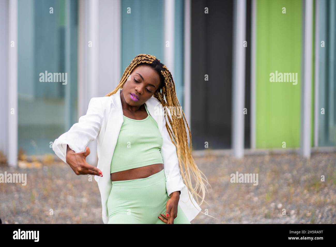 Photo with copy space of a african woman with braids dancing hip hop in ...