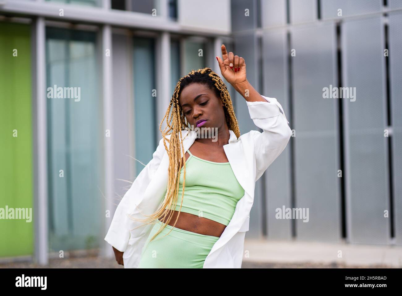 Photo with copy space of a black woman with braids dancing sensually in ...