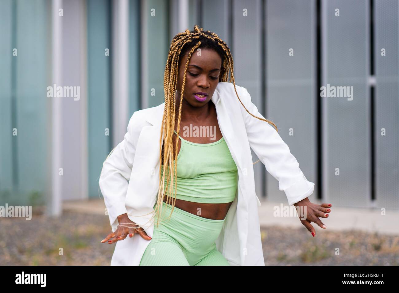 Portrait of an african woman with braids dancing with concentration ...
