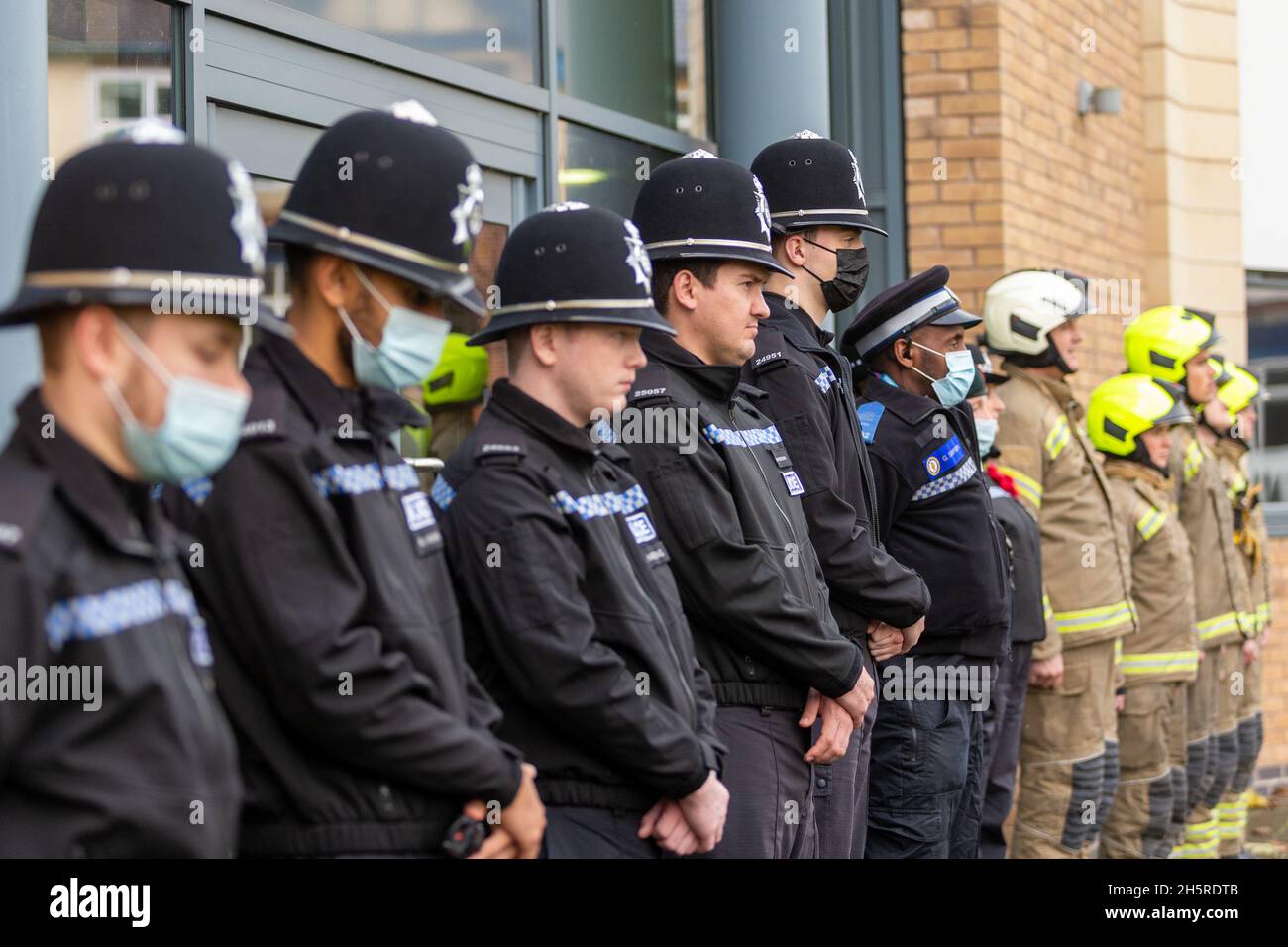 Cradley Heath, West Midlands, UK. 11th Nov, 2021. Fire and rescue service Blue Watch of Haden Cross fire station, West Midlands Fire Service in Cradley Heath, West Midlands, stand to attention with police colleagues on Remembrance Day at 11am for a two minute silence. Credit: Peter Lopeman/Alamy Live News Stock Photo