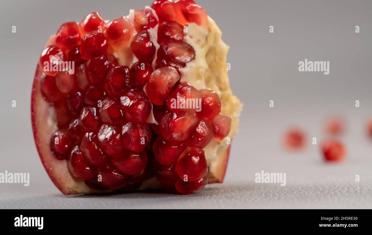 Tasty pomegranate fruit isolated on grey light background. Stock Photo