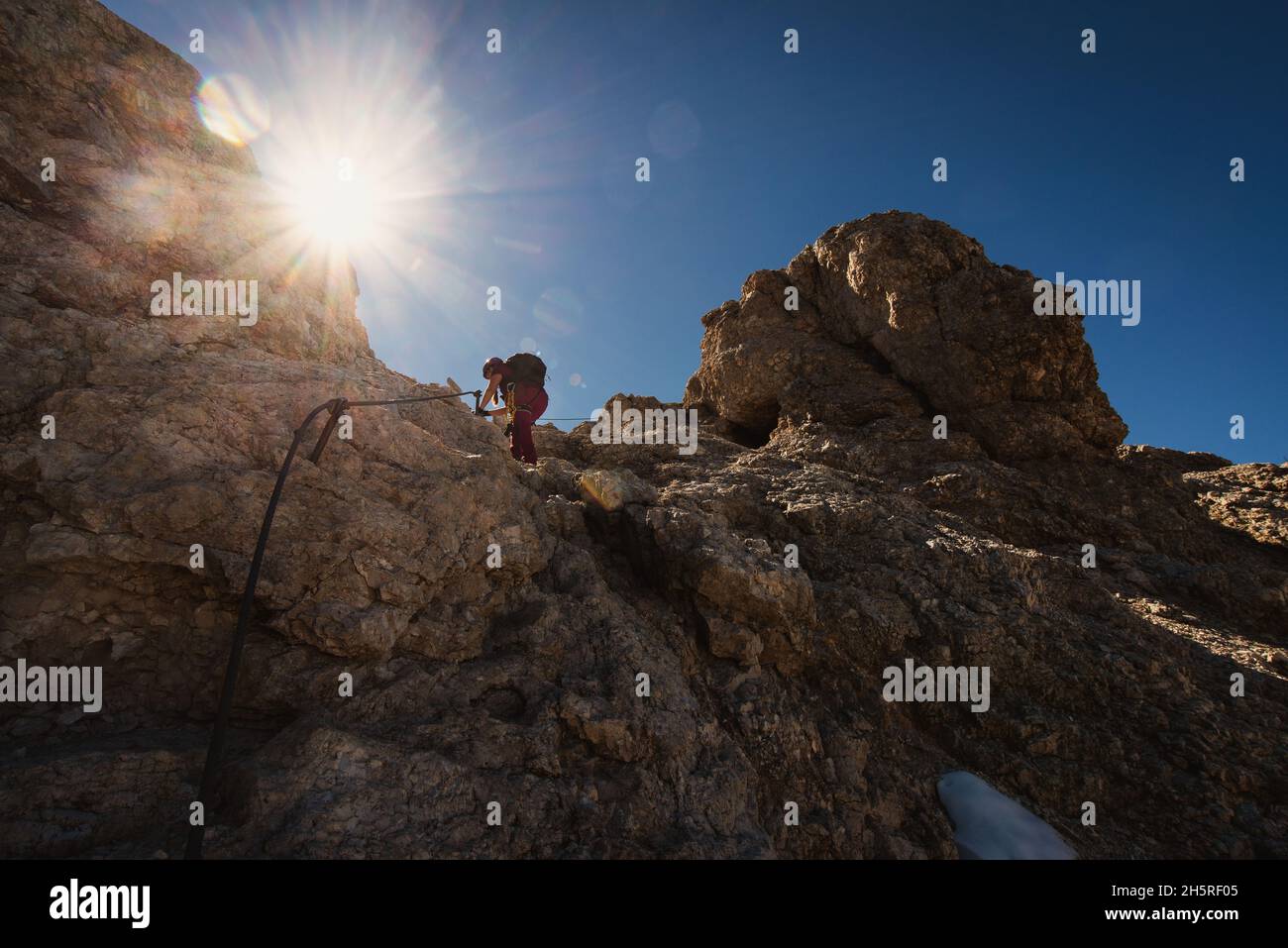 Woman climbing in the mountains Stock Photo