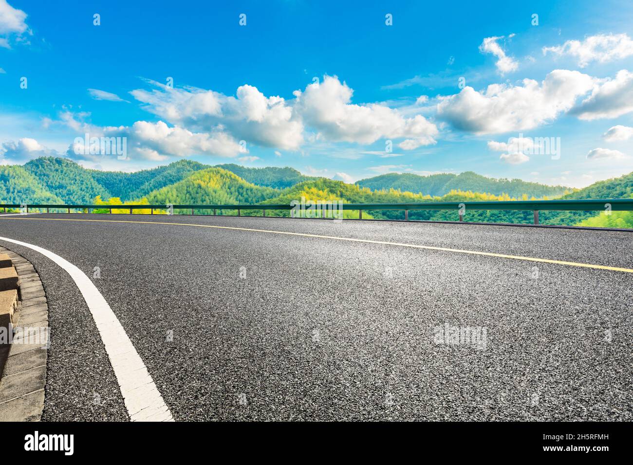 Asphalt road and green mountain with bamboo forest natural landscape ...