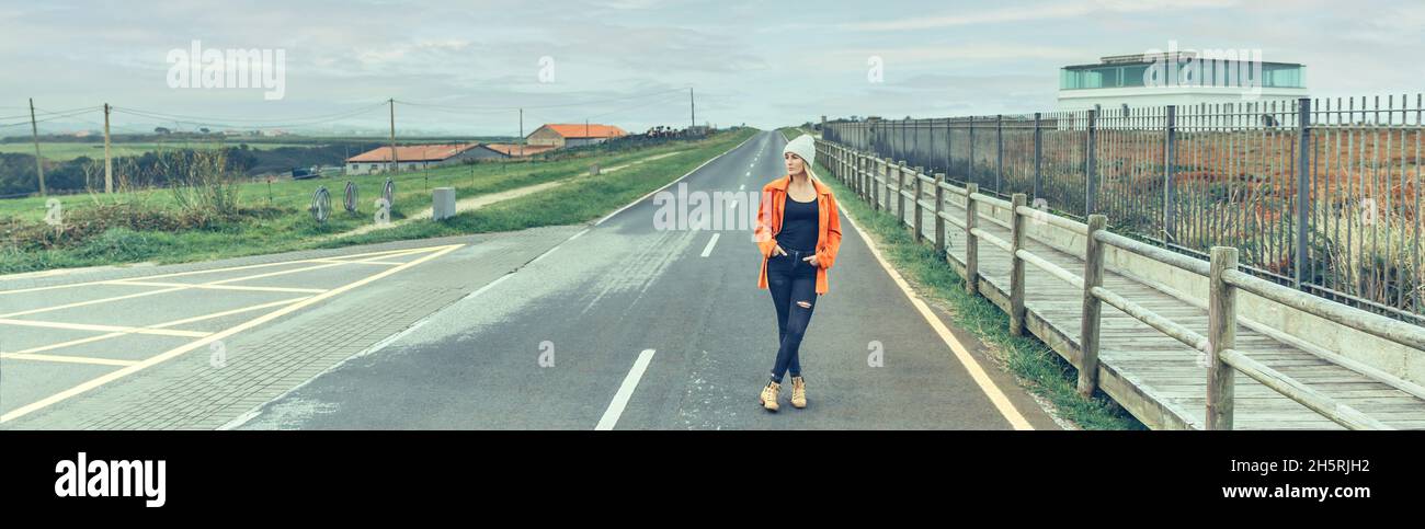 View from inside camper van of woman posing on the road Stock Photo