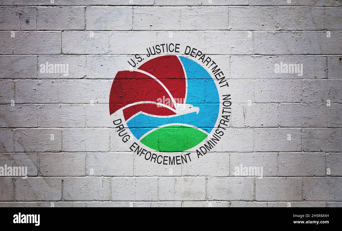 The DEA flag (Drug Enforcement Administration) painted on a brick wall. Stock Photo